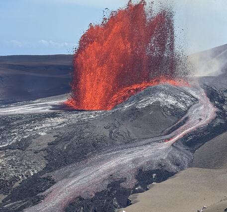 Color photograph of lava fountain and flow