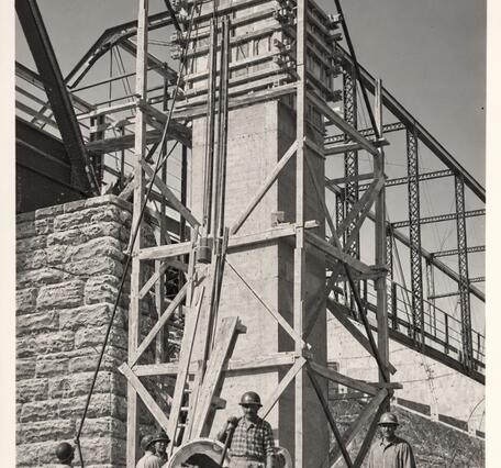 A tower is forming next to the bridge as a third level is built.