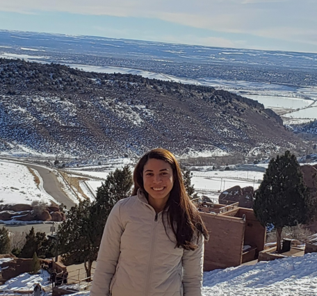 TNMCorps volunteer jessicasouza in front of a snowy landscape. 