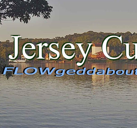 Looking across the river at a quaint town with the Newsletter title superimposed