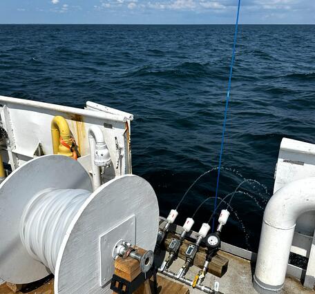 Large volume surface water sampling equipment on side of research boat on large lake