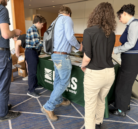 Sonya Bogle, in the middle-left corner, diligently searching for additional maps amid empty boxes, found herself nearly overwhelmed by the high demand for USGS maps.
