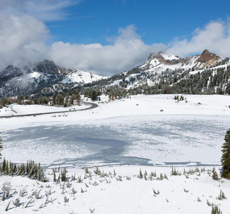 Snow on mountain with clouds in background