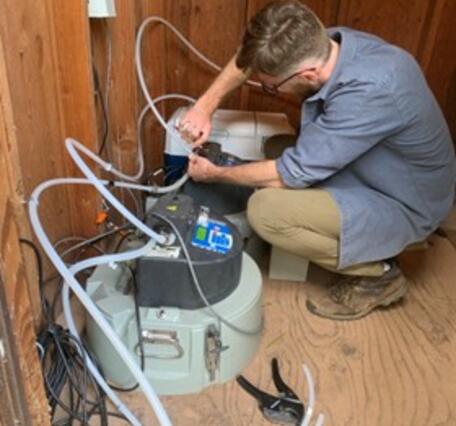 Scientist setting up equipment for storm water sampling