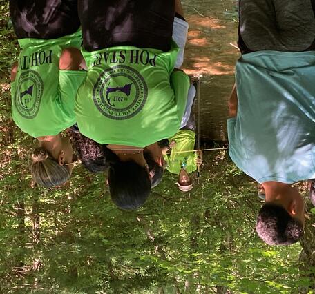 group of people in wooded area