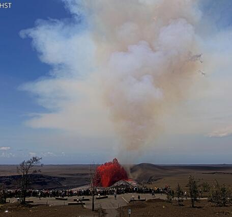 Color photograph of lava fountain and visitors