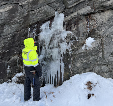 Geologist examines water bearing fractures.