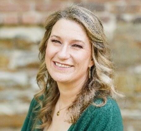 Headshot of Megan Elliott, wearing a green blouse.