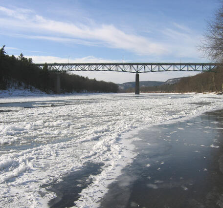 looking along a frozen Delaware River towards the Milford-Montague Bridge