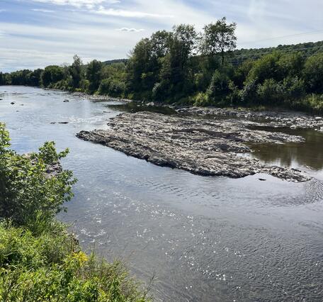 A riverbed with exposed rock. 