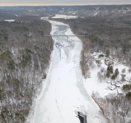 Aerial view of Montague Bridge looking downstream at the frozen Delaware River