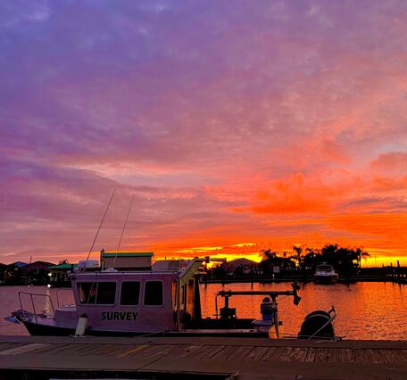 boat docked with sunset in background