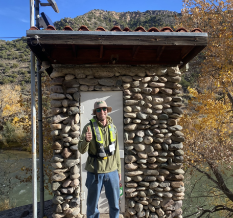 Image of Owen Bertany standing in front of a gage house