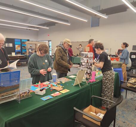 Image of USGS and EPA scientists behind tables, engaging with the public about the science we do
