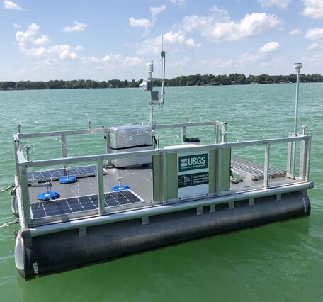A rectangular platform floats on green tinted waters