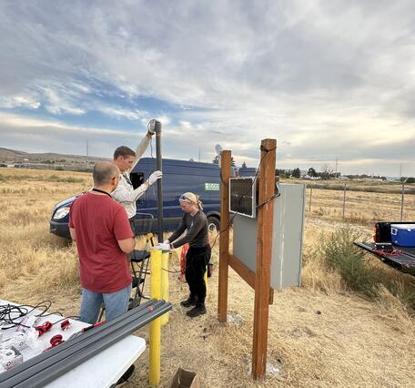 Scientists lower equipment into well