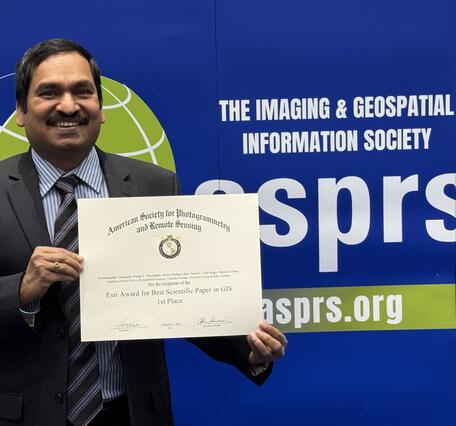 Pardhasaradhi Teluguntla presenting certificate of ESRI's Award for Best Scientific Paper in GIS -1st Place