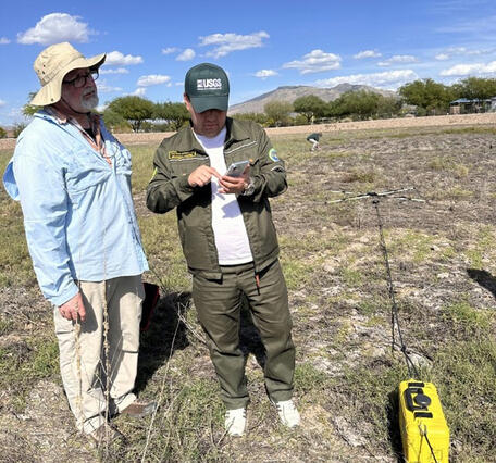 The USGS hydrologist demonstrates a new subsurface geophysics tool in the field