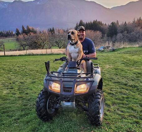 Man with dog on ATV