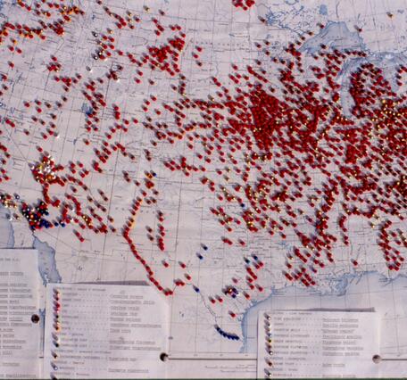 A paper map with many push pins showing observations of non-native aquatic species in the United States