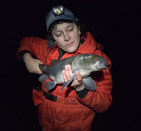 Scientist holding a Lost River Sucker fish