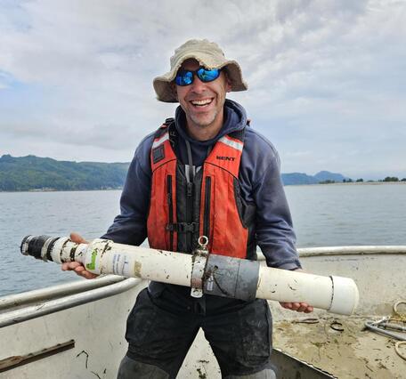 Researcher, Ryan Tomka, holding a telemetry receiver for tracking fish