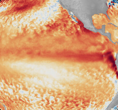 Map of Pacific Ocean showing sea surface temperatures in mostly oranges and reds