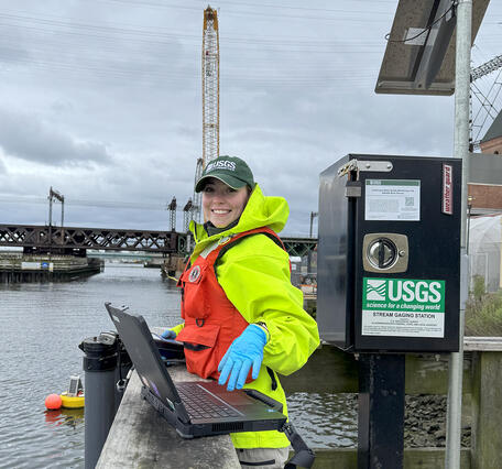 Technician performs a vertical profile and routine maintenance on continuous water quality monitors on the Norwalk River.