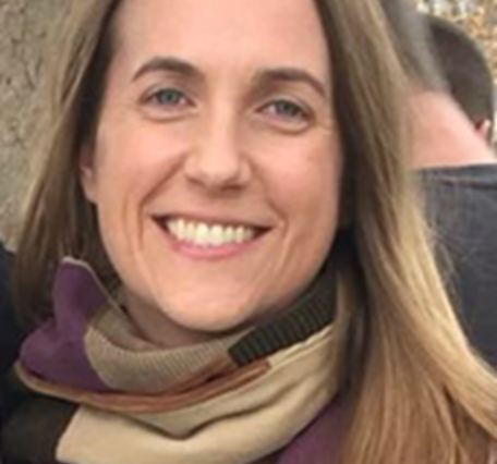 Photograph of Sarah E Peterson wearing a scarf with trees in the background