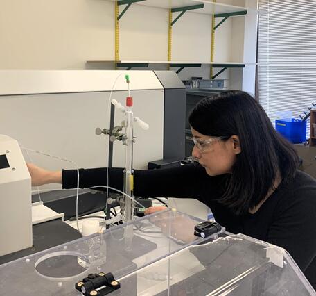 Scientist preparing laboratory machine for analysis