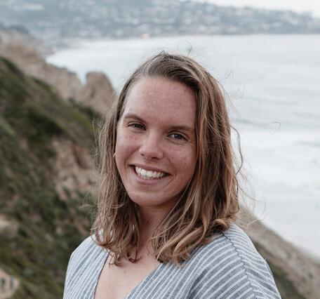 White woman with freckles and golden hair looking at camera