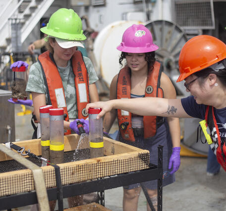 Scientists preparing push core samples during the Hawaii Abyssal Nodules Expedition