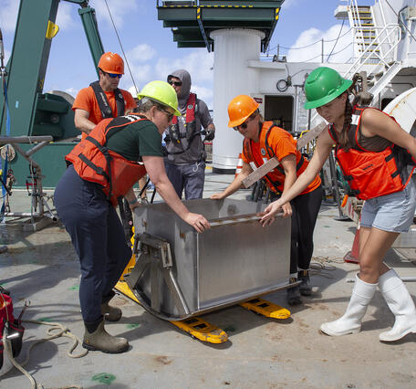 Scientists preparing to process a box core sample during the Hawaii Abyssal Nodules Expedition