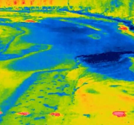 Thermal Image of the Ice on the Delaware River with bright red circles indicating the warmer water exposed by the boreholes