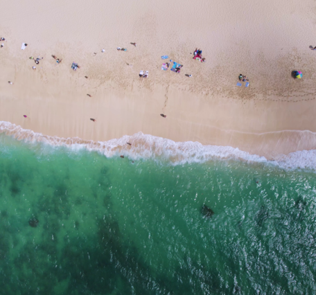 Aerial top-down footage of sandy shoreline on Oahu