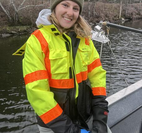 Young woman in boat wearing a PFD