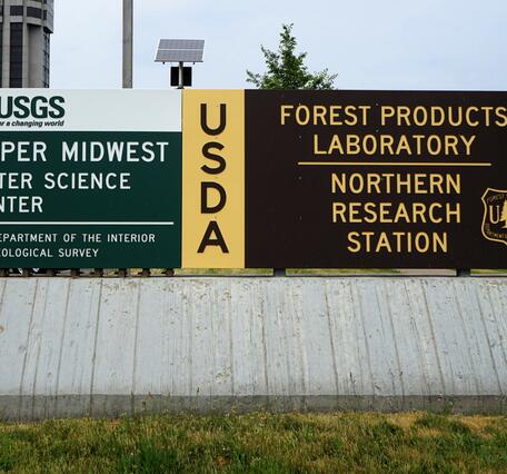 Two signs next to each other, left: USGS Upper Midwest Water Science Center, right: USDA Forest Products Laboratory