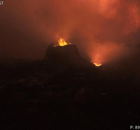 Color photograph of flames within volcanic vents at night