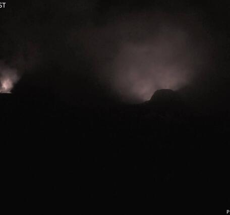 Color photograph of volcanic vents glowing at night