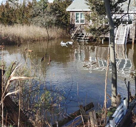 Flooded front yard of a house near the Wading River.