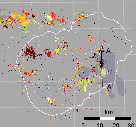 Map view and cross section with tightly clustered earthquakes depicting fluid-fault interaction in the Yellowstone area