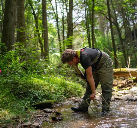 Image showing Zach Clifton conducting field measurements.