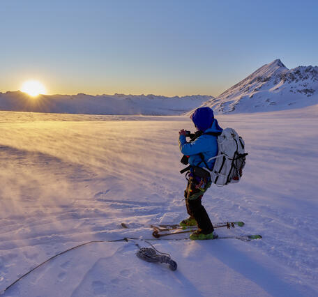 Person on skis standing on a glacier.