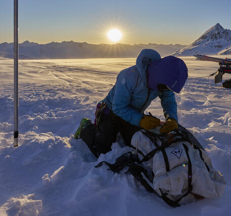 Person taking notes while on a glacier.