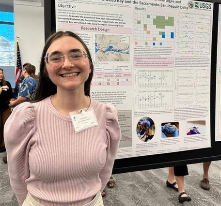 Physica Scientist, Amelia Ayers stands in front of her poster illustrating the transport of harmful algae in the Delta.