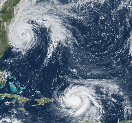 Satellite image showing Hurricane María approaching Puerto Rico, and Hurricane José on the United States East Coast.