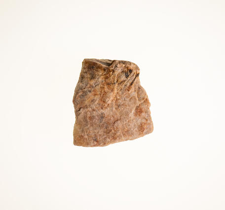 Isolated beryllium ore specimen showing coarse texture and light coloration.