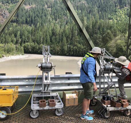 cranes on bridge over river
