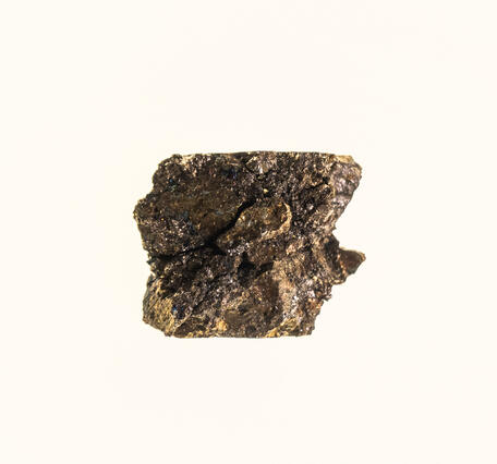 High-definition image of chalcopyrite, pentlandite, and pyrrhotite specimen showing metallic luster and granular structure.