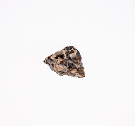 High-definition image of a second columbite-tantalite specimen, showing its dark coloration, rough surface.